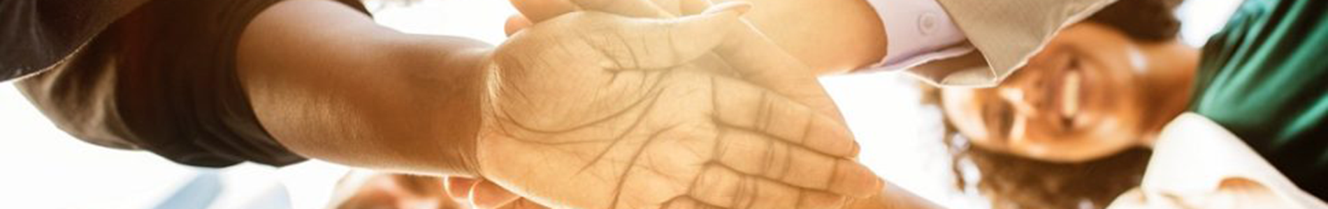 Group of people with hands in center