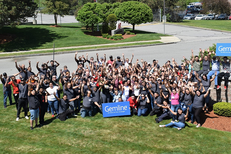 Gemline employees gather together on the lawn for a happy group picture