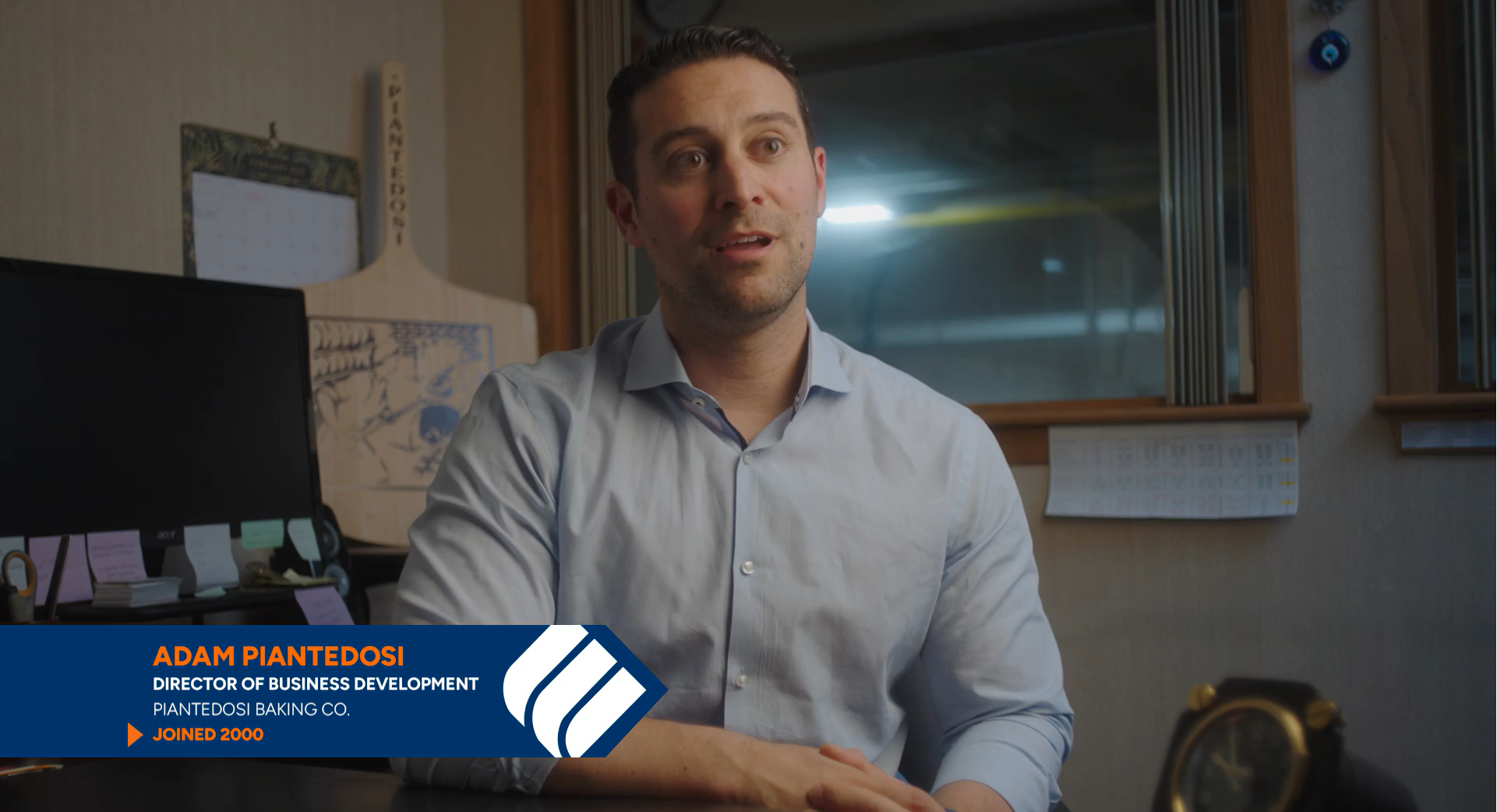 Adam Piantedosi, the Director of Business Development for Piantedosi Bakery, sits at his desk and speaks about working with Eastern Bank