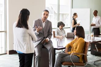 Board members gather at a meeting and discuss business