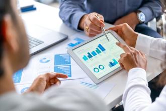 Colleagues review data together on a tablet