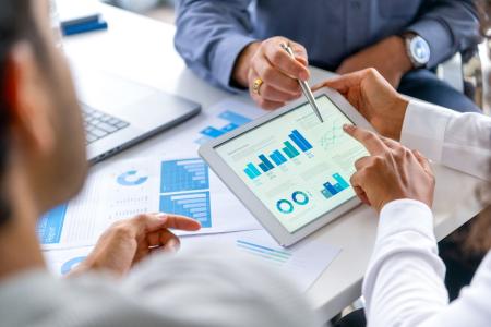 Colleagues review data together on a tablet