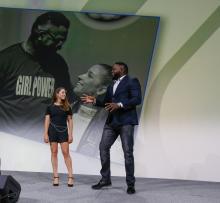 Aly Raisman stands on stage with Big Papi