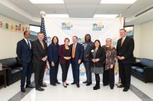 Massachusetts Housing Partnership members stand with Governor Maura Healey, Lieutenant Governor Kim Driscoll, and Eastern Bank's Bob Rivers