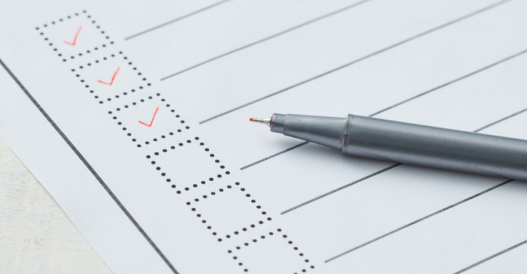 Image of a pen placed on top of a printed checklist